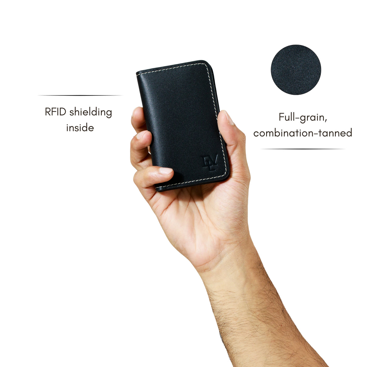 Minimal Card Holder in Black held in one hand. Notes: RFID shielding inside; full-grain, combination-tanned leather.